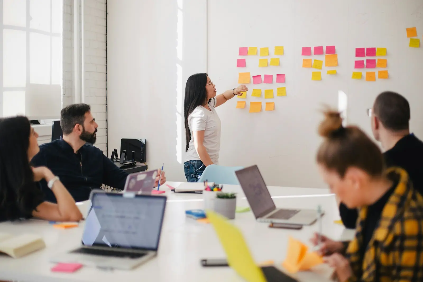 Consultants planning at a whiteboard