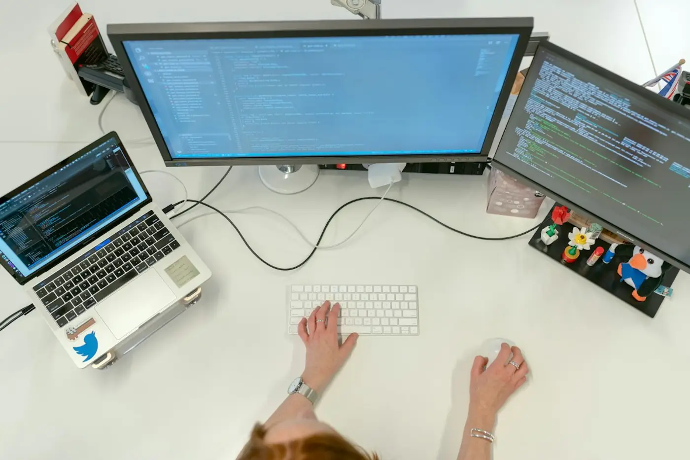 Engineer working across multiple monitors
